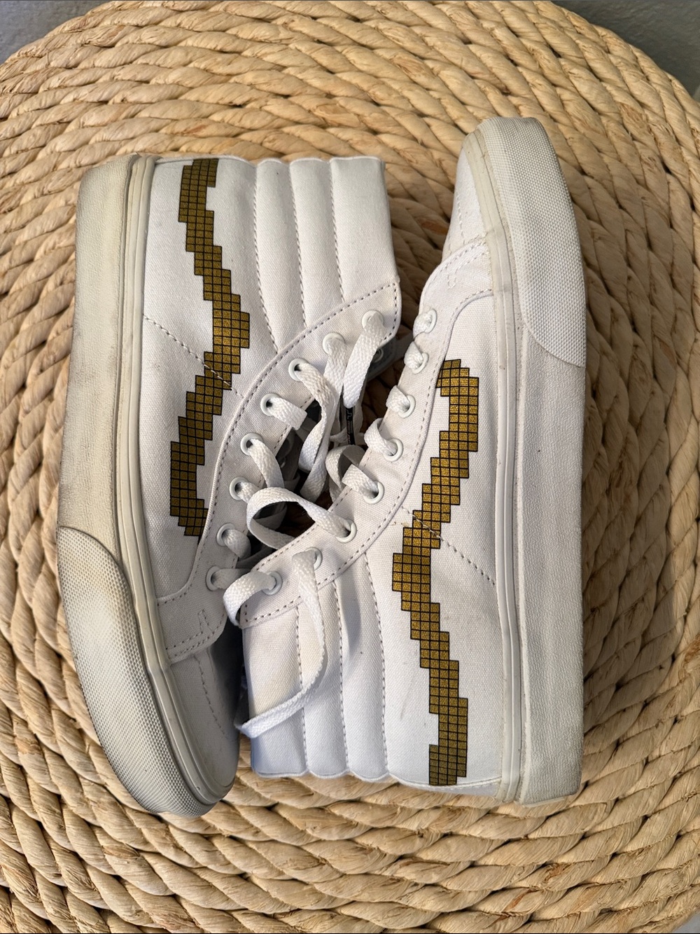 Vans Nintendo x Sk8-Hi Slim sneakers featuring a pixelated gold jazz-stripe.